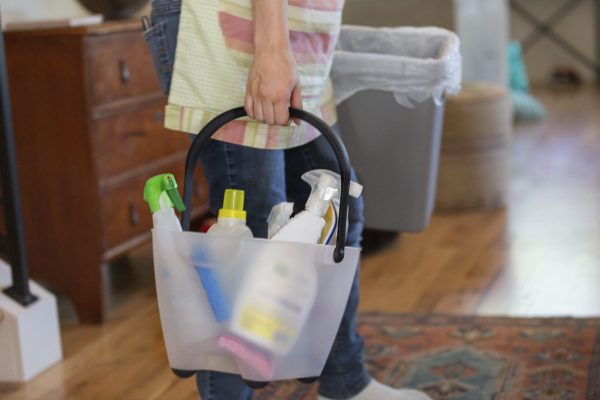 Young woman cleaning home with green cleaning products